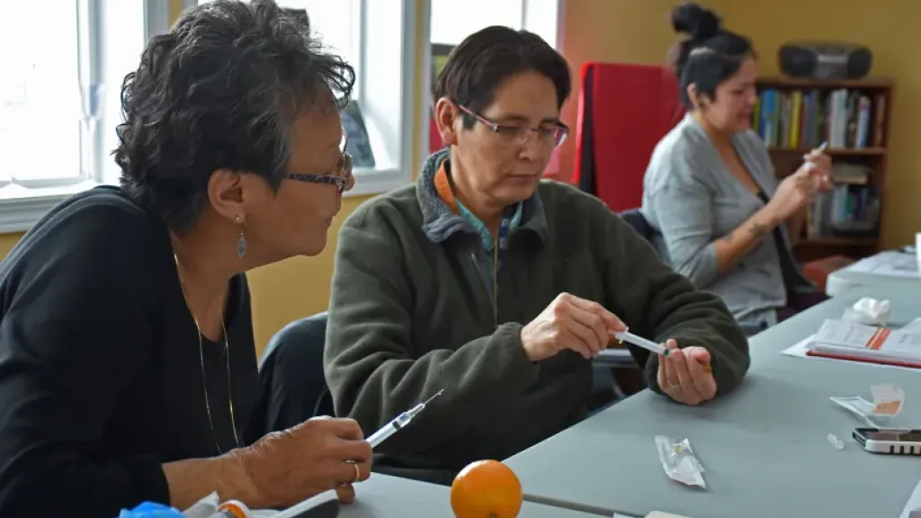 People practicing with syringes